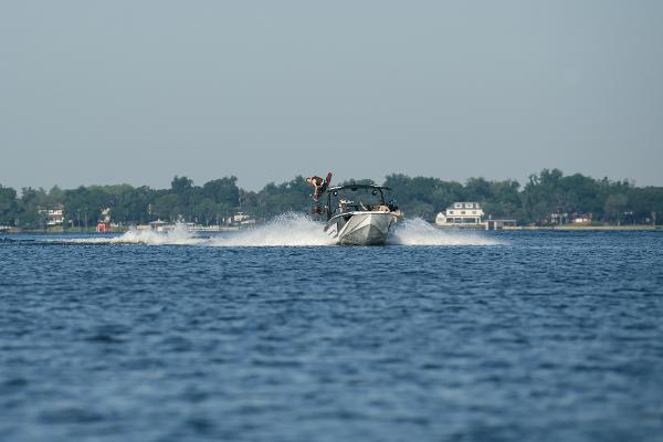 Slide: The Image of 2023 Nautique Super Air GS22E towing a wakeboarder on a lake. - 10