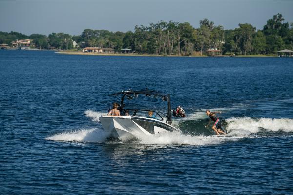 Slide: The Image of 2023 Nautique Super Air GS22E towing wakeboarder on a scenic lake. - 20