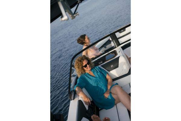 Slide: The Image of 2023 Nautique Super Air GS22E boat with passengers relaxing on the water. - 35