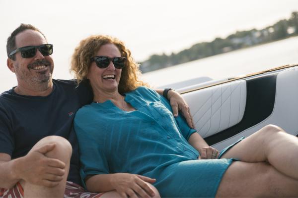 Slide: The Image of Couple enjoying a ride on a 2023 Nautique Super Air GS22E boat. - 42