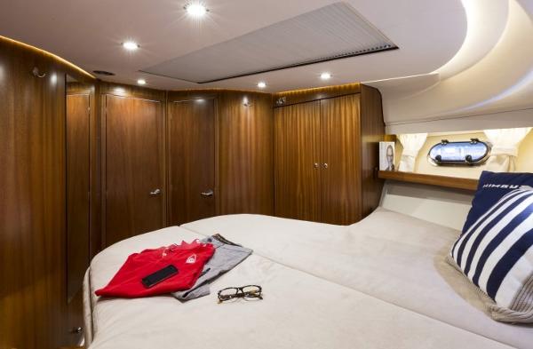 Slide: The Image of Luxurious bedroom interior of 2025 Nimbus 405 Coupé yacht with wooden cabinets. - 14
