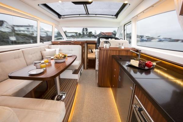 Slide: The Image of Luxurious interior of 2025 Nimbus 405 Coupé yacht with dining area and kitchenette. - 19