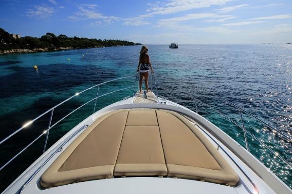 Slide: The Image of Woman on the deck of a 2025 Nimbus 405 Coupé yacht, enjoying the ocean view. - 5