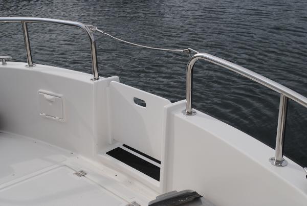 Slide: The Image of Nordic Tug 34 (2025) boat deck with stainless steel railings and water view. - 3