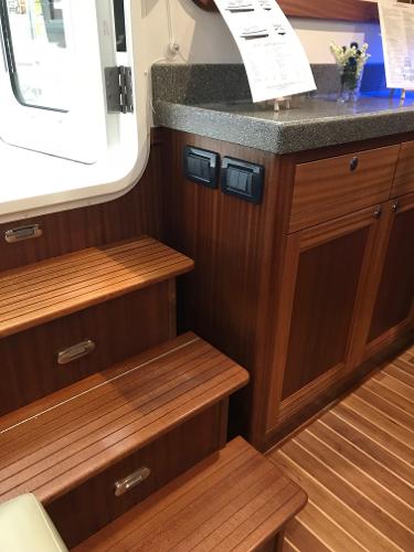 Slide: The Image of Interior of 2025 Nordic Tug 34 with wooden steps and cabinetry. - 5