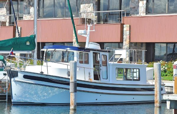 Slide: The Image of 2025 Nordic Tug 34 docked at a marina. - 8