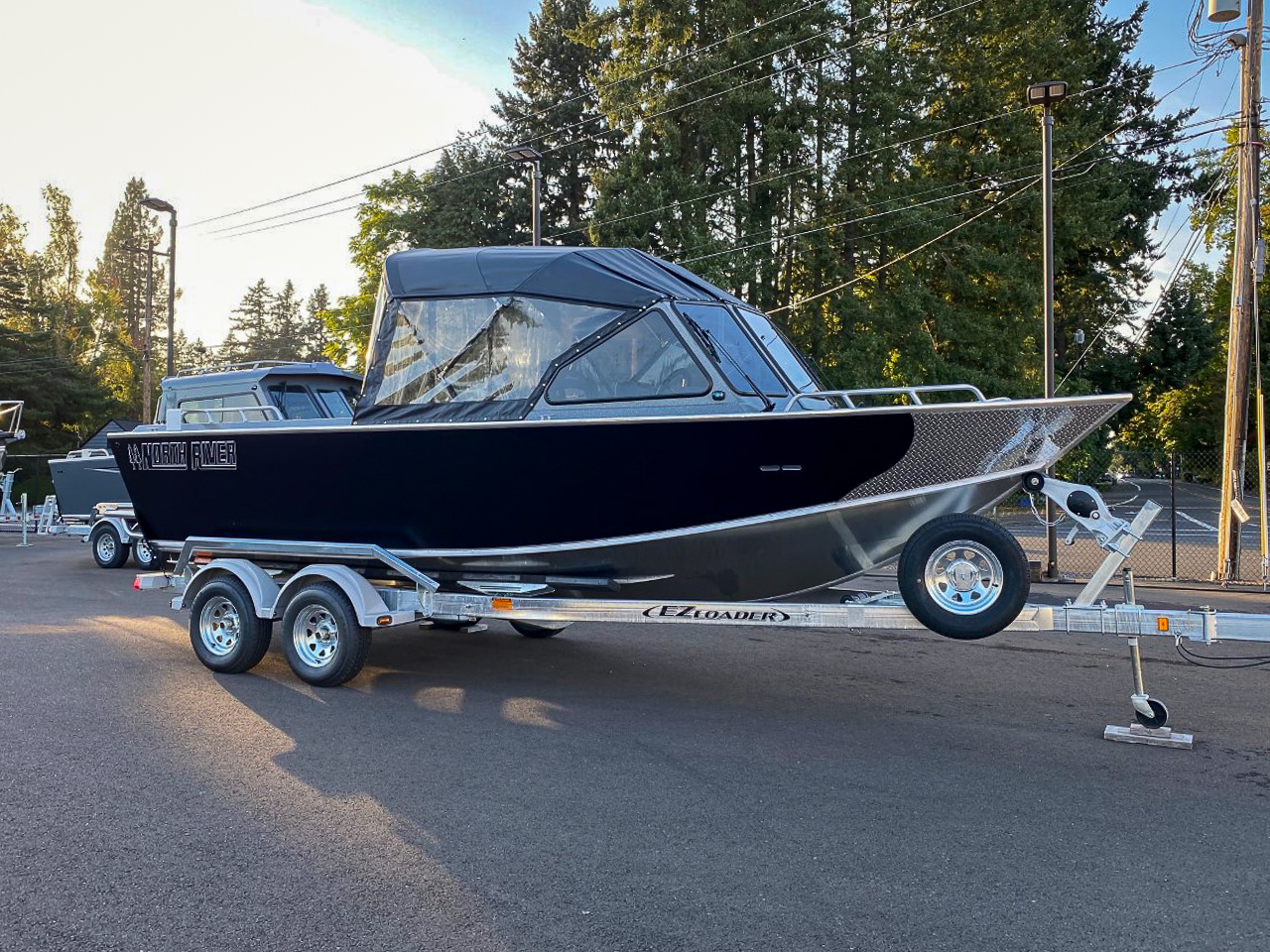 Slide: The Image of 2025 North River 22 Seahawk boat on EZ Loader trailer in outdoor setting. - 1