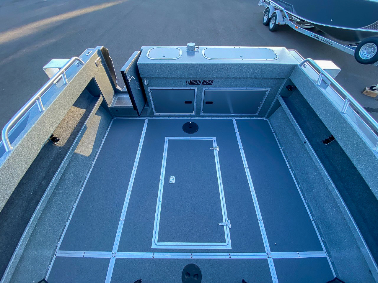 Slide: The Image of 2025 North River 22 Seahawk boat interior with storage compartments and non-slip flooring. - 19