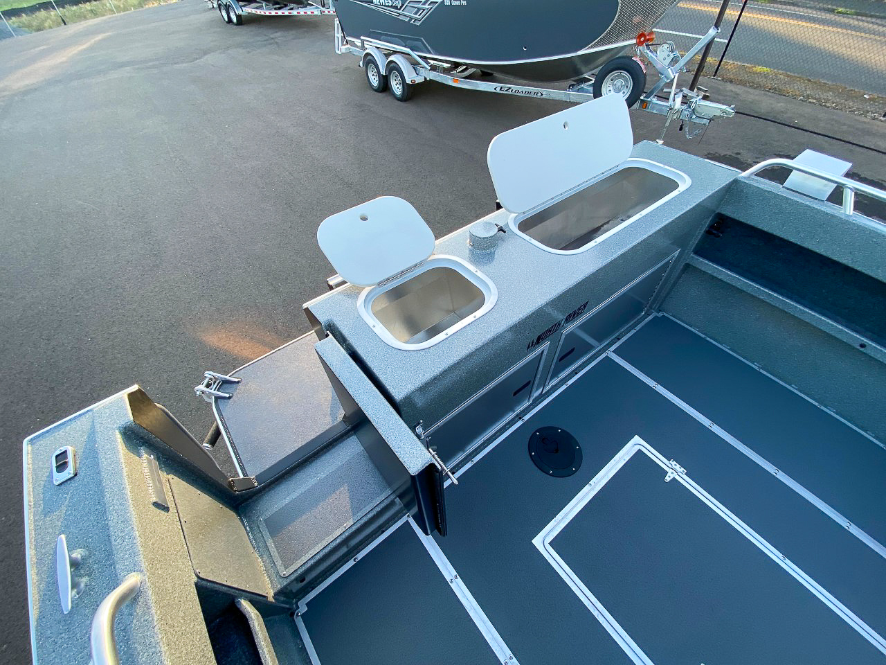 Slide: The Image of 2025 North River 22 Seahawk boat interior with storage compartments and clean deck. - 22