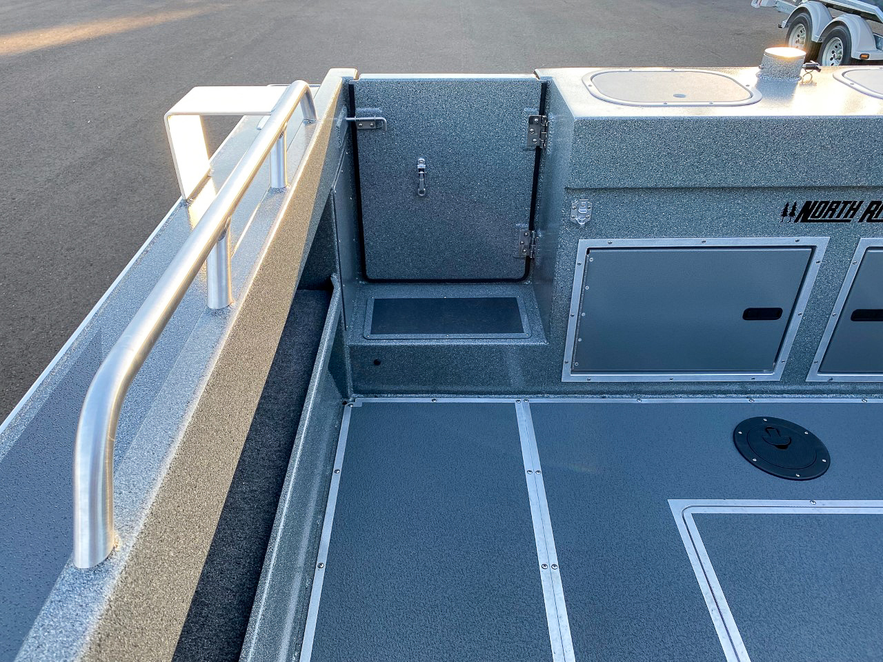 Slide: The Image of 2025 North River 22 Seahawk boat interior with storage compartments and railing. - 23