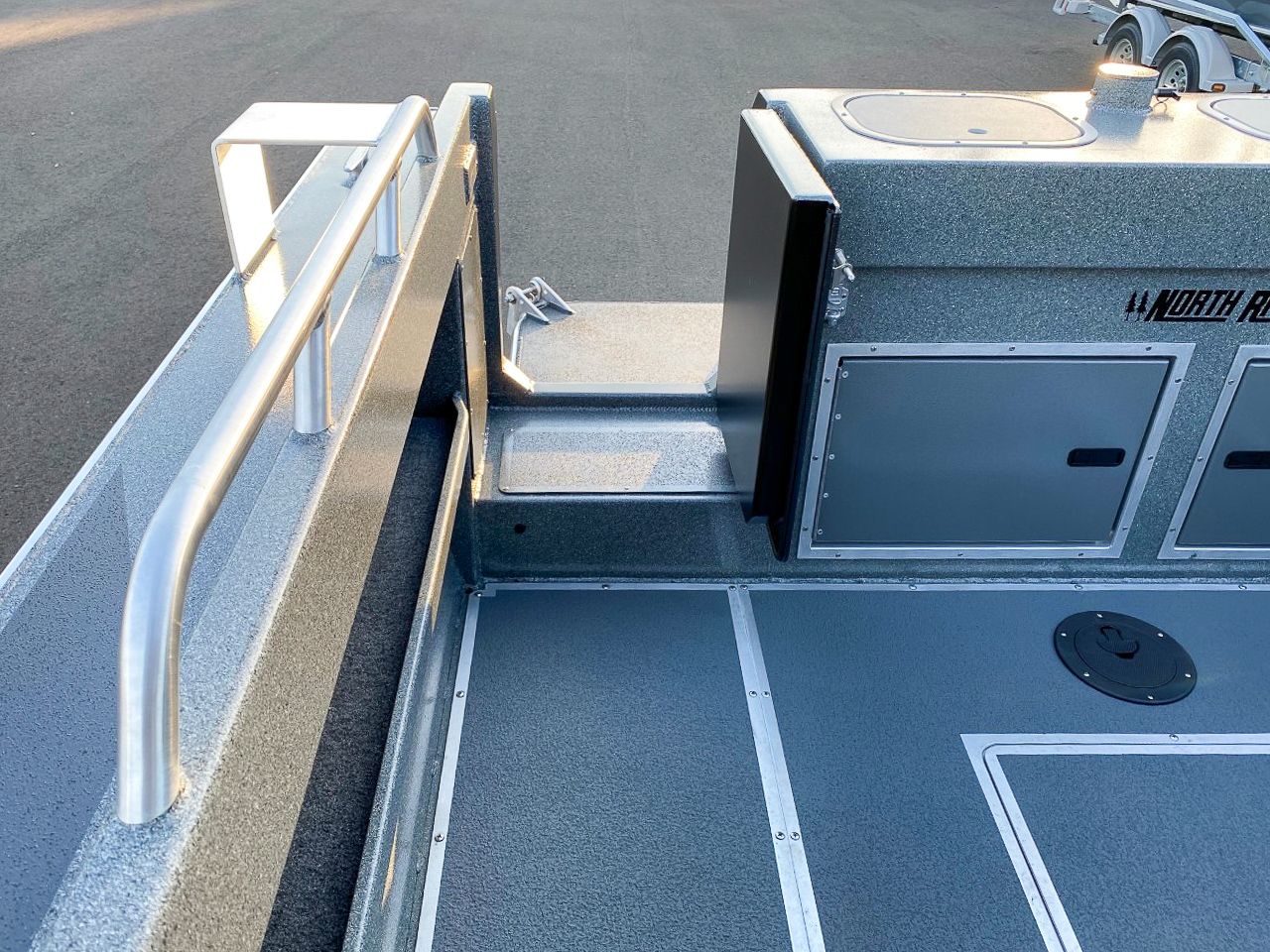 Slide: The Image of 2025 North River 22 Seahawk boat deck with storage compartments and railing. - 24