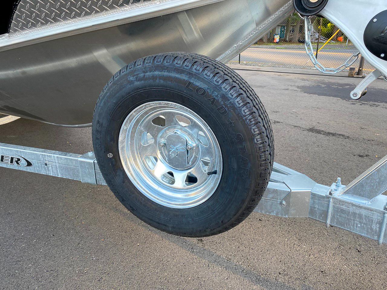 Slide: The Image of Close-up of a 2025 North River 22 Seahawk boat trailer tire. - 28