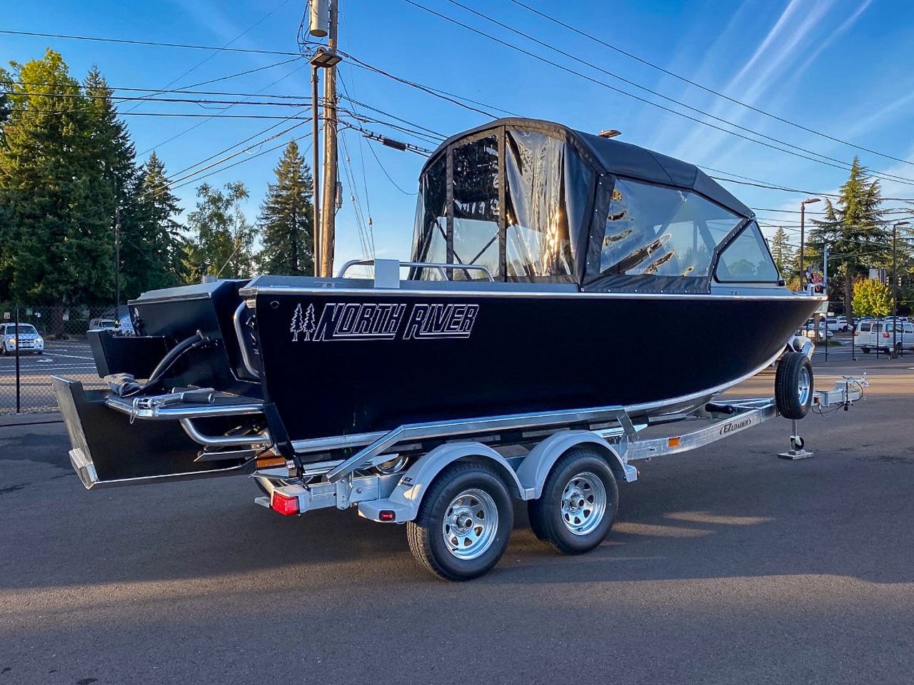Slide: The Image of 2025 North River 22 Seahawk boat on a trailer in a parking lot. - 3