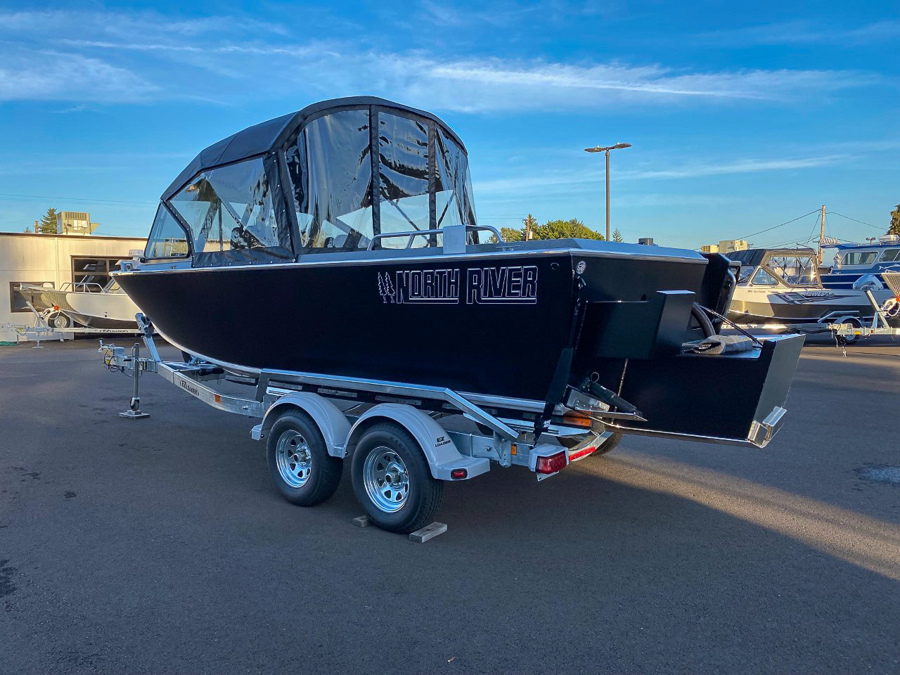 Slide: The Image of 2025 North River 22 Seahawk boat on a trailer in a marina. - 5