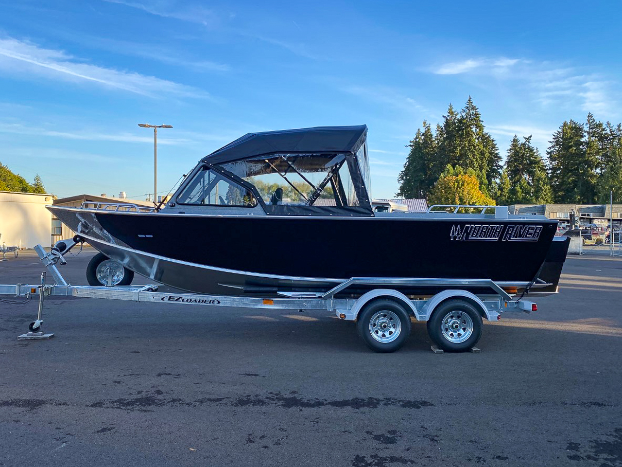 Slide: The Image of 2025 North River 22 Seahawk boat on EZ Loader trailer in parking lot. - 6