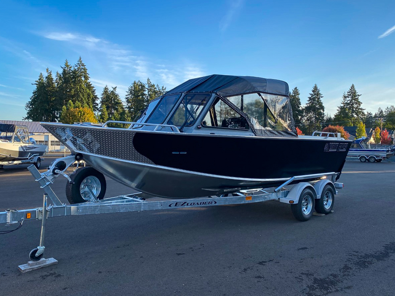 Slide: The Image of 2025 North River 22 Seahawk boat on a trailer in a parking lot. - 7
