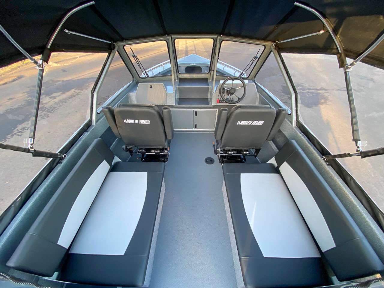 Slide: The Image of Interior of 2025 North River 22 Seahawk boat with seating and steering console. - 9