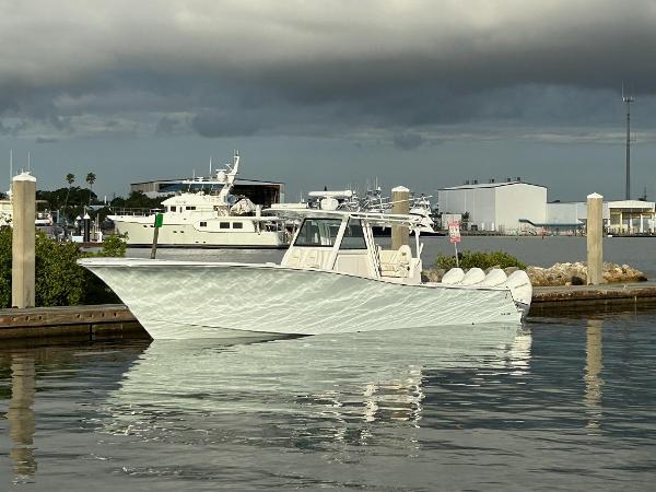 Slide: The Image of 2021 Onslow Bay 41 Tournament Edition boat docked in a marina under cloudy skies. - 1