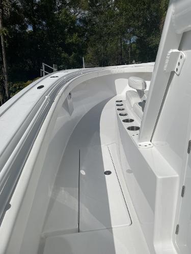 Slide: The Image of 2021 Onslow Bay 41 Tournament Edition boat interior with rod holders and seating. - 10