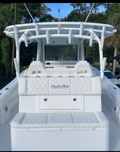 Slide: The Image of 2021 Onslow Bay 41 Tournament Edition boat with white seating and rod holders. - 16