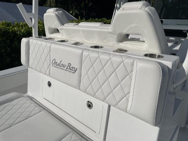 Slide: The Image of 2021 Onslow Bay 41 Tournament Edition boat seating with diamond-stitched upholstery and cup holders. - 17