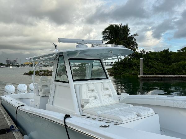 Slide: The Image of 2021 Onslow Bay 41 Tournament Edition boat docked by lush greenery and calm waters. - 5