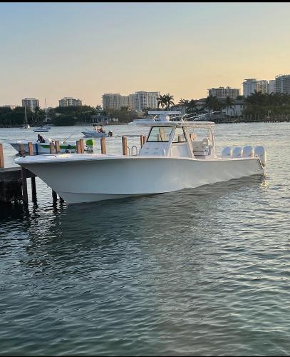 Slide: The Image of 2021 Onslow Bay 41 Tournament Edition boat docked in a scenic marina. - 6