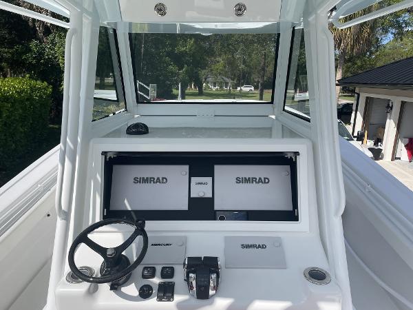 Slide: The Image of 2021 Onslow Bay 41 Tournament Edition boat dashboard with Simrad navigation system. - 8
