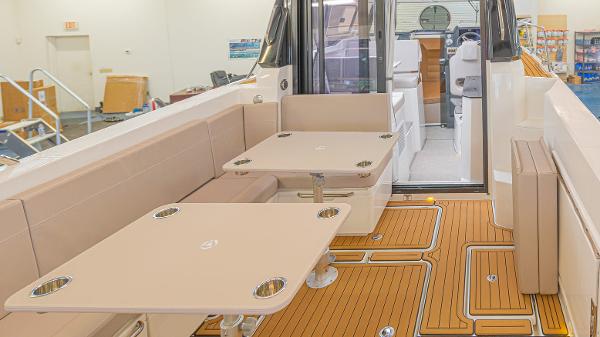 Slide: The Image of 2024 Parker Poland 920 Explorer Max boat interior with seating and tables. - 8