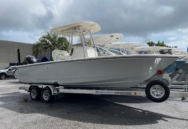 Slide: The Image of 2024 Pathfinder 2400 Open boat on a trailer in a parking lot. - 0