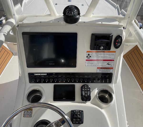 Slide: The Image of Control panel of a 2024 Pathfinder 2500 Hybrid boat with navigation instruments. - 10