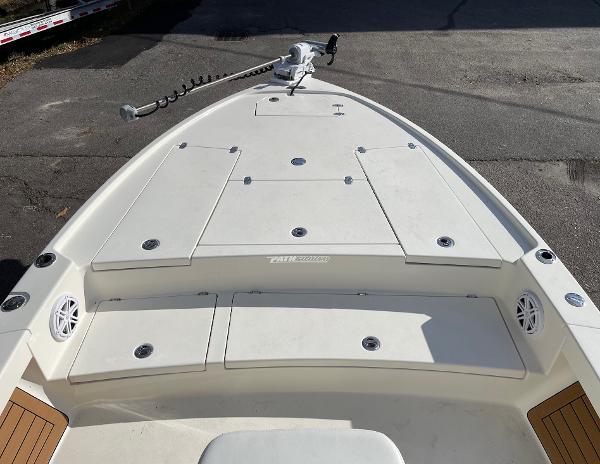 Slide: The Image of 2024 Pathfinder 2500 Hybrid boat deck with storage compartments and trolling motor. - 14
