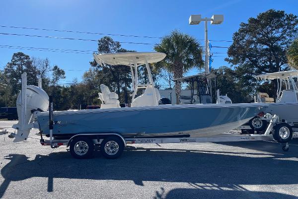 Slide: The Image of 2024 Pathfinder 2500 Hybrid boat on a trailer in a sunny outdoor setting. - 2