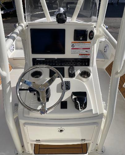 Slide: The Image of 2024 Pathfinder 2500 Hybrid boat console with steering wheel and navigation controls. - 9