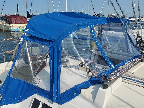 Slide: The Image of 1987 Pearson 31-2 sailboat with blue canvas cockpit cover in marina. - 1