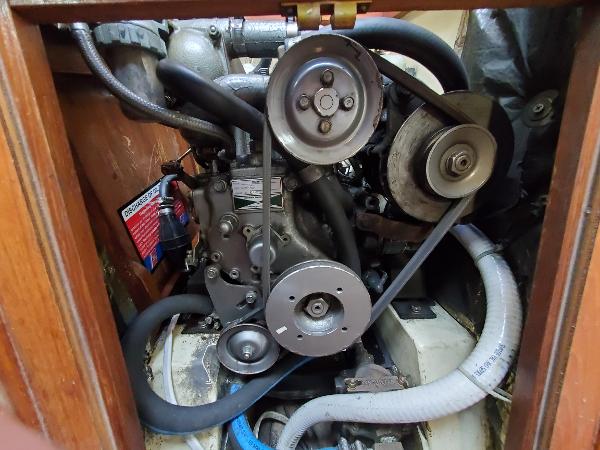 Slide: The Image of Engine compartment of a 1987 Pearson 31-2 sailboat, showing belts and hoses. - 10
