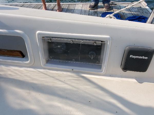 Slide: The Image of 1987 Pearson 31-2 sailboat cockpit with Raymarine equipment and instrument panel. - 4