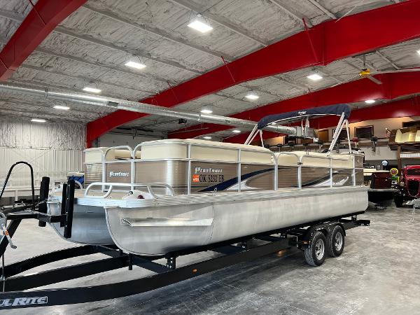 Slide: The Image of 2013 PlayCraft 2400 Clipper pontoon boat on trailer in indoor storage facility. - 0