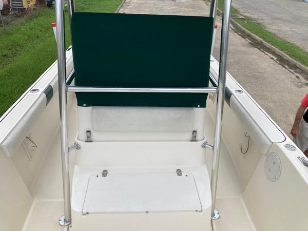 Slide: The Image of 1998 Pursuit 2270 Center Console boat interior with green seat cover and white deck. - 4