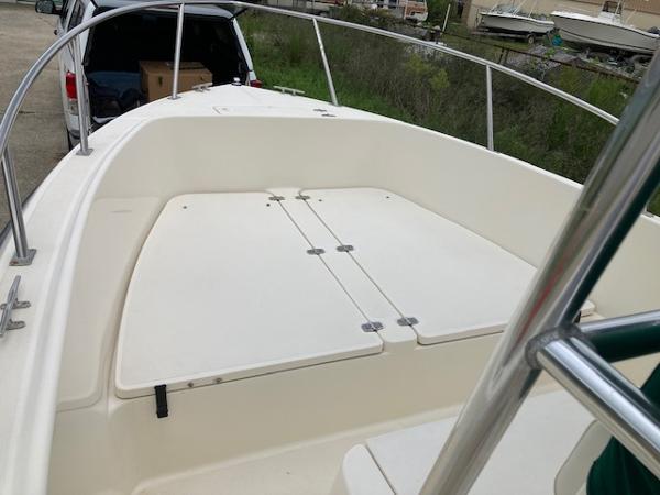 Slide: The Image of 1998 Pursuit 2270 Center Console boat deck with storage compartments. - 7