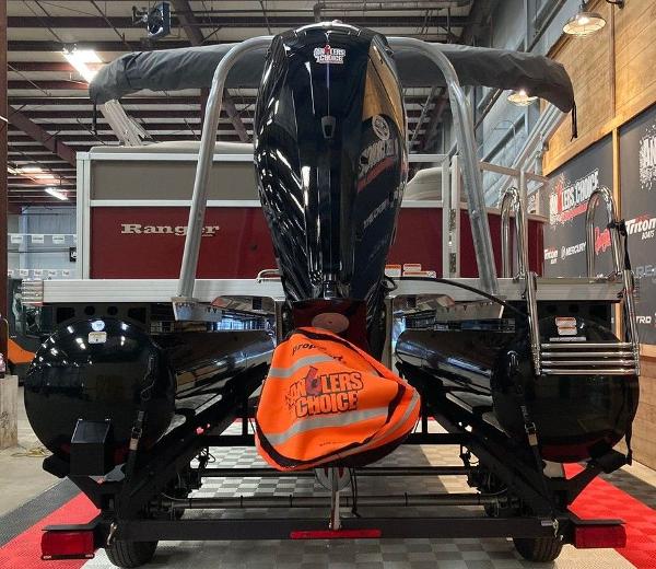 Slide: The Image of 2024 Ranger 200C pontoon boat displayed indoors with a powerful outboard motor. - 1