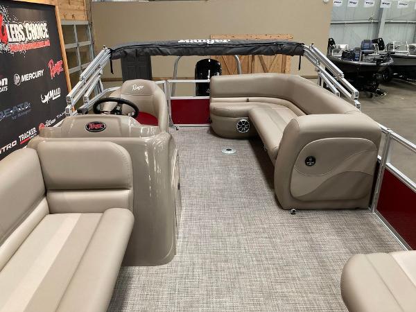 Slide: The Image of 2024 Ranger 200C pontoon boat interior with beige seating and steering console. - 2