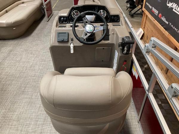 Slide: The Image of 2024 Ranger 200C boat cockpit with steering wheel and beige captain's chair. - 4