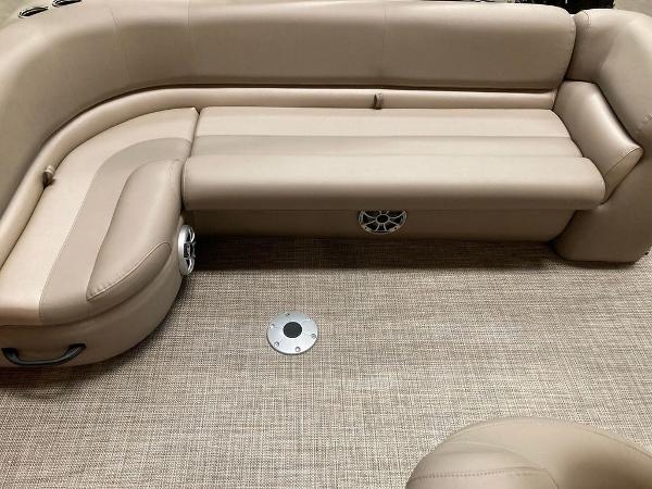 Slide: The Image of 2024 Ranger 200C boat interior with beige leather seating and carpeted floor. - 5