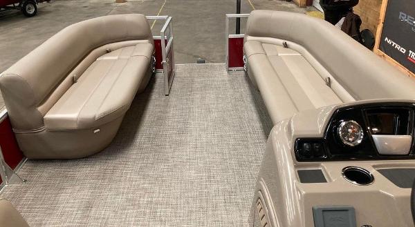 Slide: The Image of 2024 Ranger 200C pontoon boat interior with beige seating and modern dashboard. - 8
