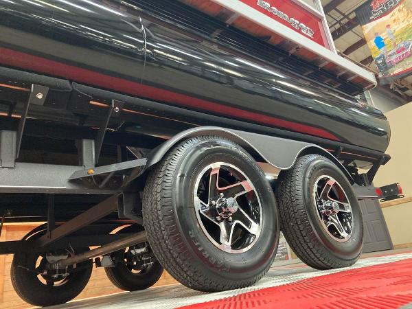 Slide: The Image of 2024 Ranger 200C boat trailer with dual wheels in showroom. - 9