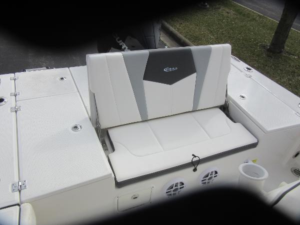 Slide: The Image of 2024 Robalo 226 Cayman boat with white and gray cushioned seating. - 8