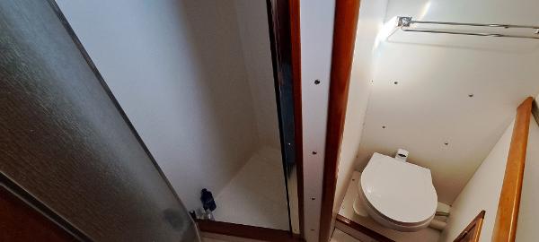 Slide: The Image of 1999 Rozema Boat Works Custom 42 bathroom with toilet and shower - 14