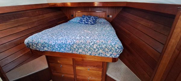 Slide: The Image of Cozy cabin bed in 1999 Rozema Boat Works Custom 42 with wooden interior. - 16