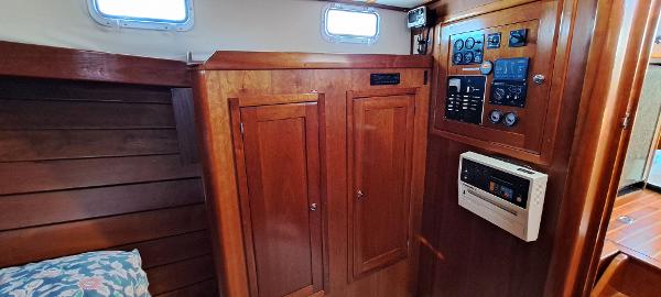 Slide: The Image of Interior cabin of 1999 Rozema Boat Works Custom 42 with wooden cabinetry and control panel. - 19